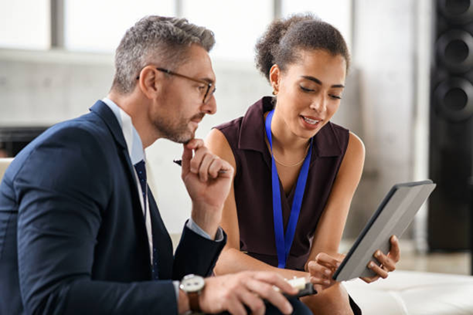 Man and woman reviewing a tablet together, thoughtfully noticing their thoughts