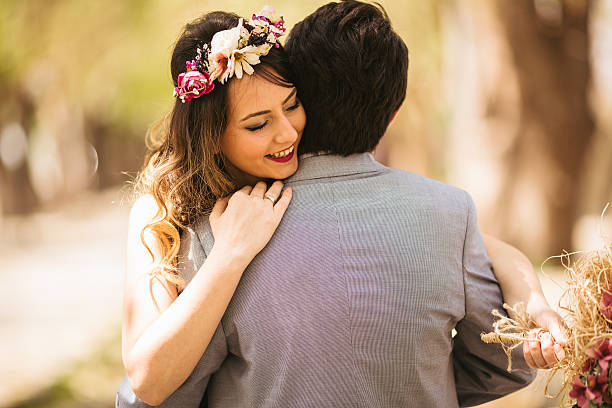 Smiling couple hugging outdoors